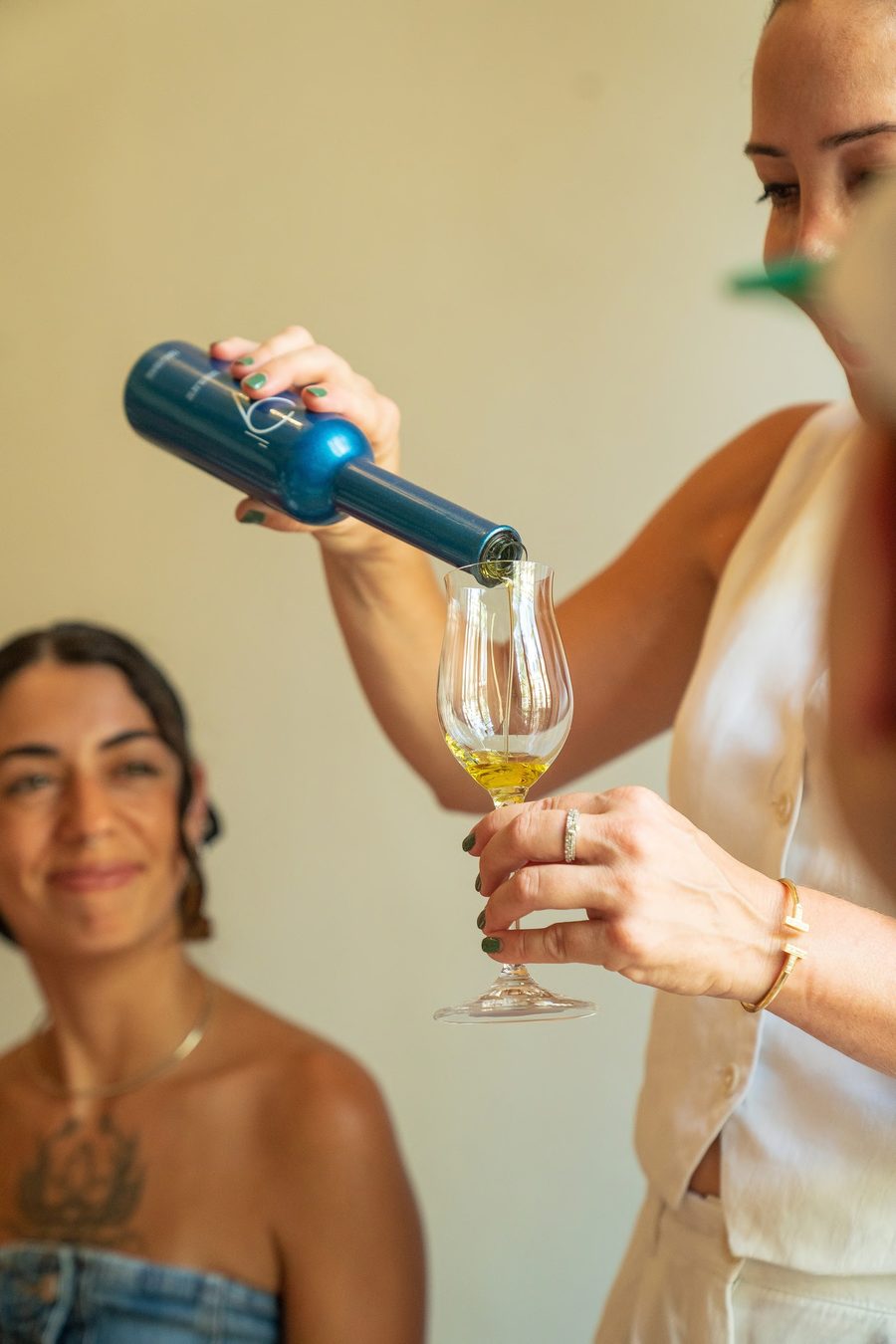 Olive oil being poured into a tasting glass at the Olive Passion showroom